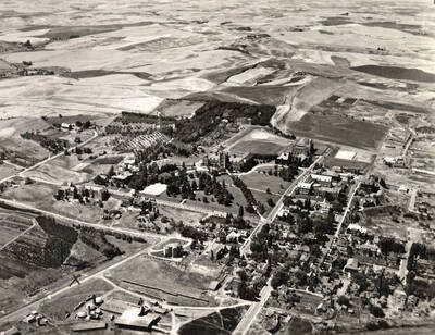 1935 photograph of University of Idaho campus. Aerial view shows surrounding farm fields.