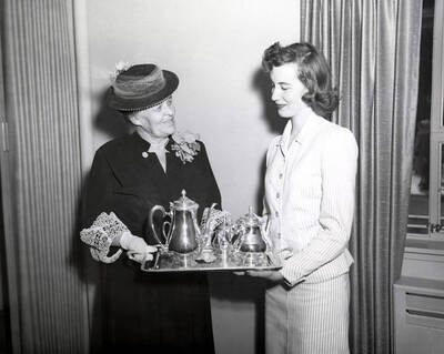 1953 photograph of Gifts. Mrs. A.A. Steel presenting silver service to Ethel Steel House representative Betty Ruth Westerberg.
