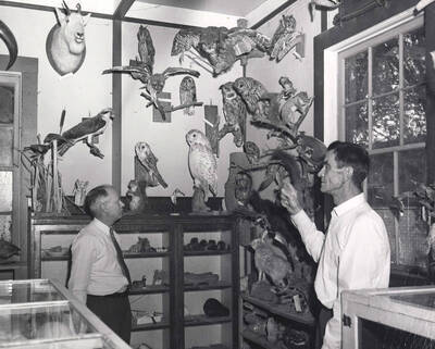 1953 photograph of Gifts. l-r: H. Walter Steffens, Henry Lorang. Donor: Publications Dept.