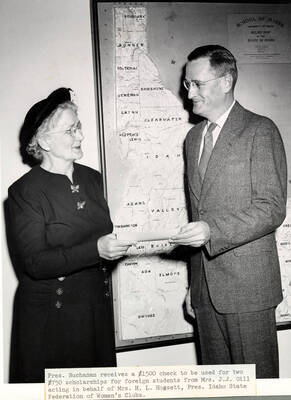1947 photograph of Gifts. Mrs. J. J. Gill presents a check to President Buchanan. Donor: Publications Dept.