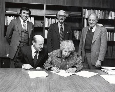 1980 photograph of Gifts. Looking on, l-r: Michael Towers, Richard Gibb, Warren Owens, Ernest W. Hartung.