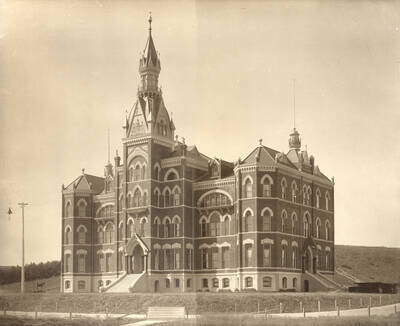 1900 photograph of Administration Building. View of the old Administration building with a horse on the left.