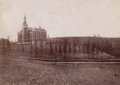 1902 photograph of Administration Building. View of the old administration Building and lawn.