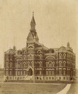 1903 photograph of Administration Building. View of the old Administration building with electrical poles in front.