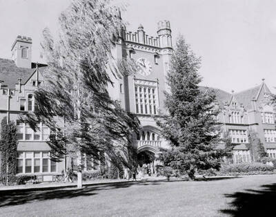 1950 photograph of Administration Building. View of clock tower and students.