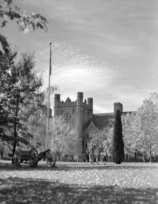 1948 photograph of Administration Building. View of the lawn, with the cannon flag on the left.
