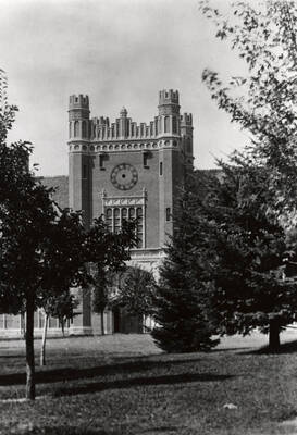 1934 photograph of Administration Building. View of the clock tower between the trees. Donor: Cal Warnick.