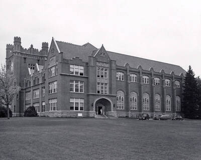 1960 photograph of Administration Building. View of students and automobiles at the north entrance.