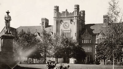1923 photograph of Administration Building. View of Spanish-American War Memorial statue.