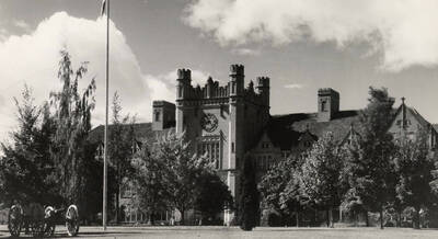 1930 photograph of Administration Building. View of University of Idaho Cannons on lawn.