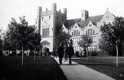 1920 photograph of Administration Building. View of Hello Walk and students.