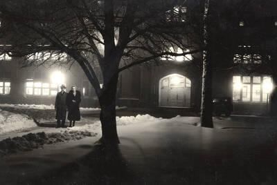 1931 photograph of Administration building with a couple in front.