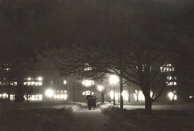1931 photograph of Administration Building with a couple in front.