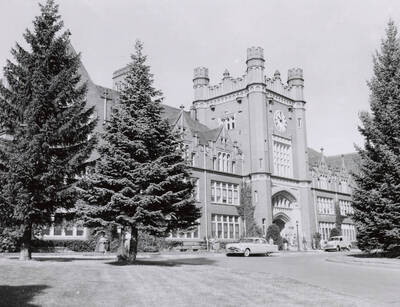 1953 photograph of Administration Building. View of the drive with automobiles.