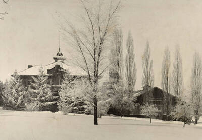 1926 photograph of Gymnasium. View of the lawn in the winter.