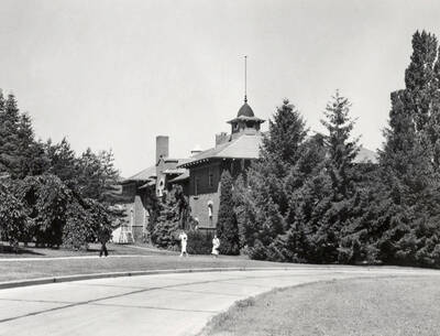 1936 photograph of Gymnasium. View of students walking to class.