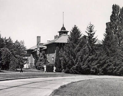1936 photograph of Gymnasium. View of students walking to class.
