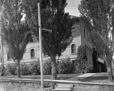 1911 photograph of Ridenbaugh Hall. View of the east side with wooden sidewalks.