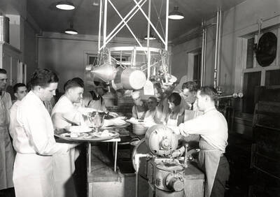 1936 photograph of Hays Hall. View of the kitchen and staff.