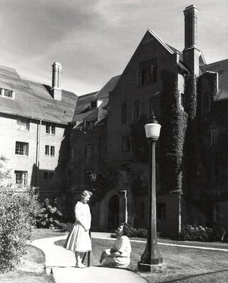 1954 photograph of Hays Hall. Students shown sitting on steps. Donor: Publications Dept.