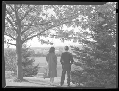 1944 photograph of University of Idaho campus scenery. View of students looking at campus.