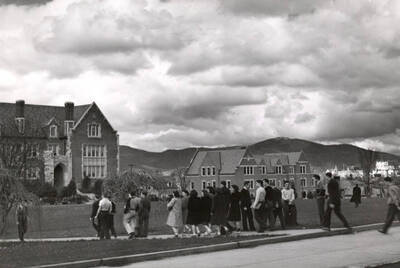 1940 photograph of University of Idaho campus scene. View of students walking to class.