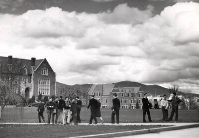 1946 photograph of University of Idaho campus scene. View of students and soldiers walking to class