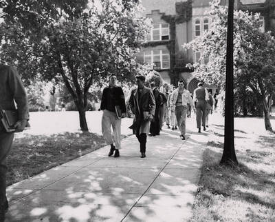 1941 photograph of University of Idaho campus scenery. Students showed walking to class. Donor: Publications Dept.