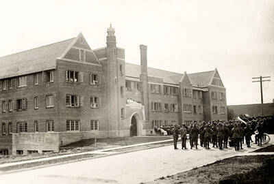 1923-06-11 photograph of Forney Hall. View of military band on the way to the dedication.