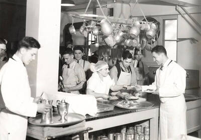 1936 photograph of Forney Hall. View of kitchen and staff.