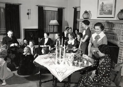 1930 photograph of Forney Hall. Members gathered for a tea.