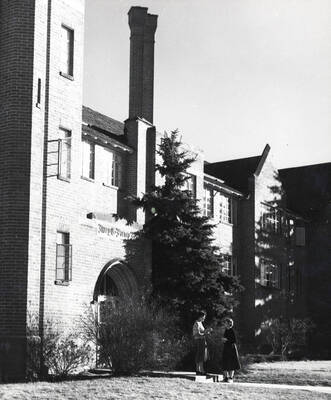 1940 photograph of Forney Hall. View of residents next to building entrance. Donor: Publications Dept.