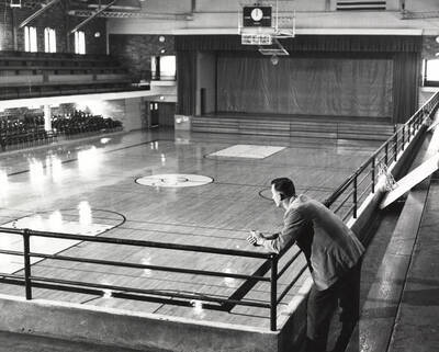 1960 photograph of Memorial Gymnasium. Joe Cipriano looks at his basketball court.