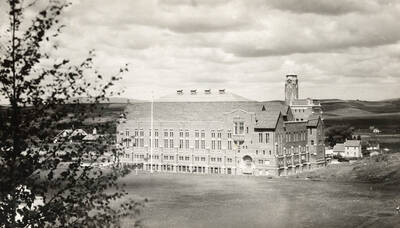 1930 photograph of Memorial Gymnasium. View from the top of the hill with fields in the background. Donor: Virginia R. Vanderhoff.