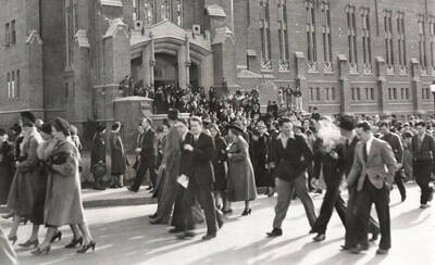 1940 photograph of University of Idaho campus scene. View of students walking out of Memorial Gymnasium.