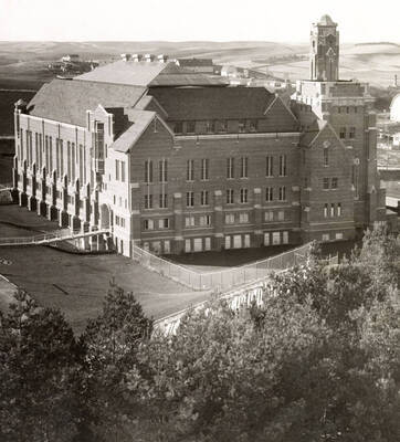 1930 photograph of Memorial Gymnasium. View of the southeast corner with farms in the background.
