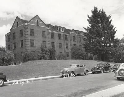 1947 photograph of Lindley Hall. Street with automobiles out front.