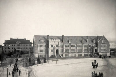 1925 photograph of Science Hall Renamed Life Sciences Building in 1964. View of students walking to class in the winter.