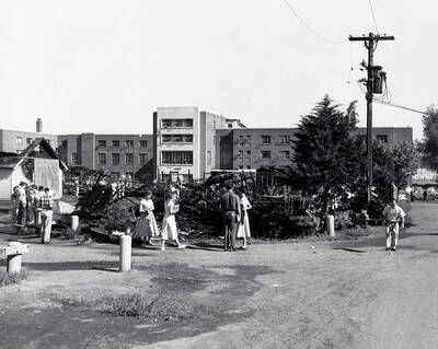 1958 photograph of Campus Club. Students survey the aftermath of the fire.