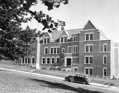 1938 photograph of Infirmary. View from lawn automobile parked on street.