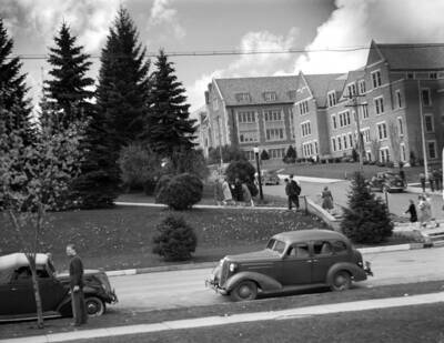 1945 photograph of Infirmary. View of Hello Walk and students.