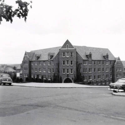 1952-05-01 photograph of Willis Sweet Hall (renamed Carol Ryrie Brink Hall in the early 1980s)View from the corner automobiles on the streets. Donor: Gary Cox.