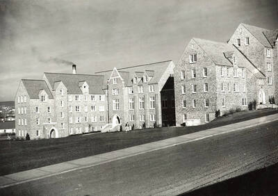1939 photograph of Chrisman Hall. View from the street with student walking to class.