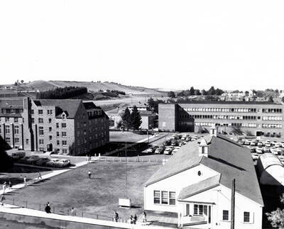 1960 photograph of Chrisman Hall. View of students walking to classes.