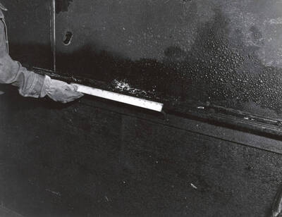 1970-05-01 photograph of Navy Building. Fire inspector takes measurements. Donor: Alumni Office.