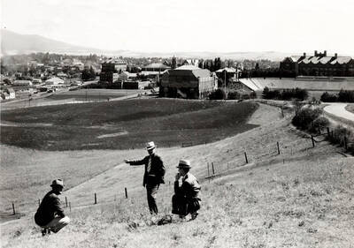 1936 photograph of Neale Stadium Cap Horton, Ted Bank, and Rafe Gibbs examine site.