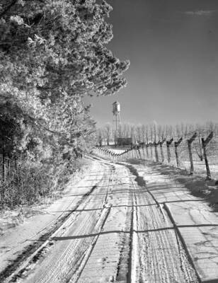 1948 photograph of I Tower. View of the fence lined road.