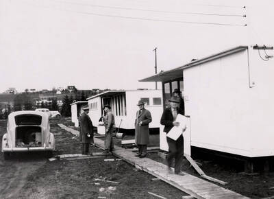 1946 photograph of Park Village. View of prefabricated housing units, automobiles, and Moscow in the background.