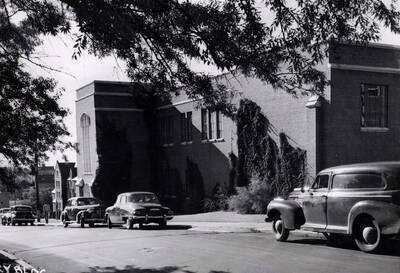 1948 photograph of Dairy Science Building. View looking west from Idaho, automobiles parked in front.