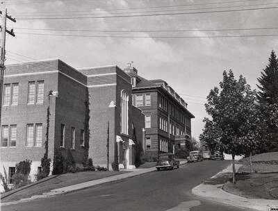 1948 photograph of Dairy Science Building. View looking east from Idaho, automobiles parked in front.